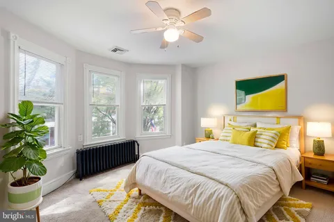 a bedroom with a bed potted plant with the outer view