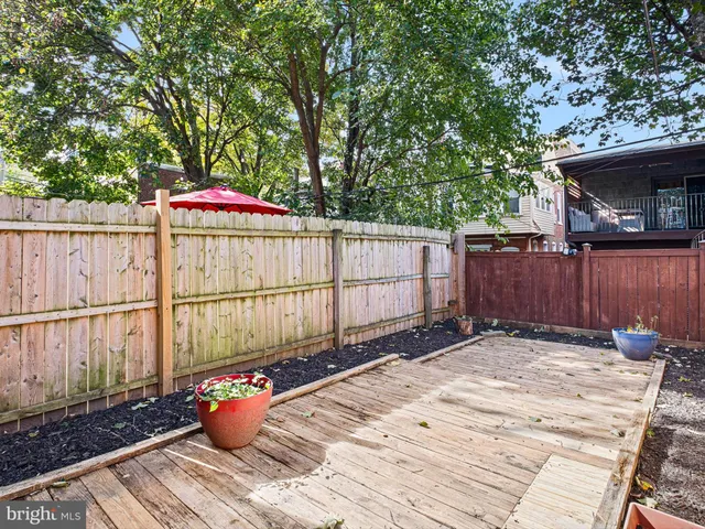 a view of a backyard with a small cabin and a chair