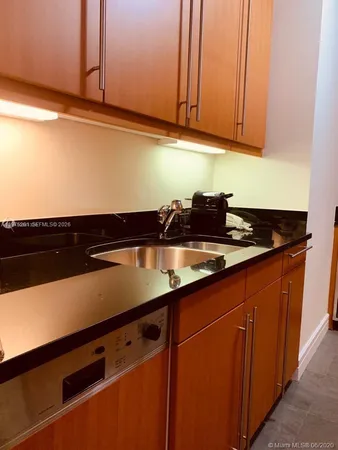 a kitchen with stainless steel appliances granite countertop a refrigerator and a stove