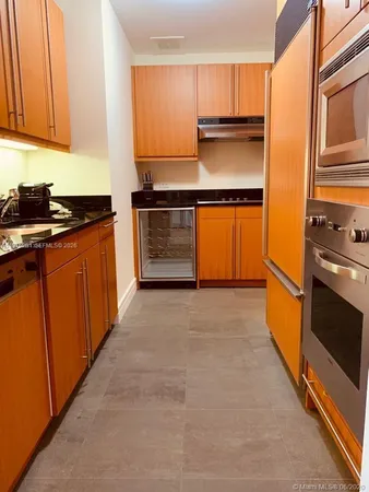 a kitchen with stainless steel appliances granite countertop a stove and a microwave