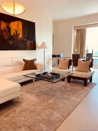 a living room with furniture and a lamp