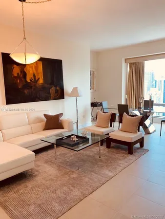 a living room with furniture a rug and a window