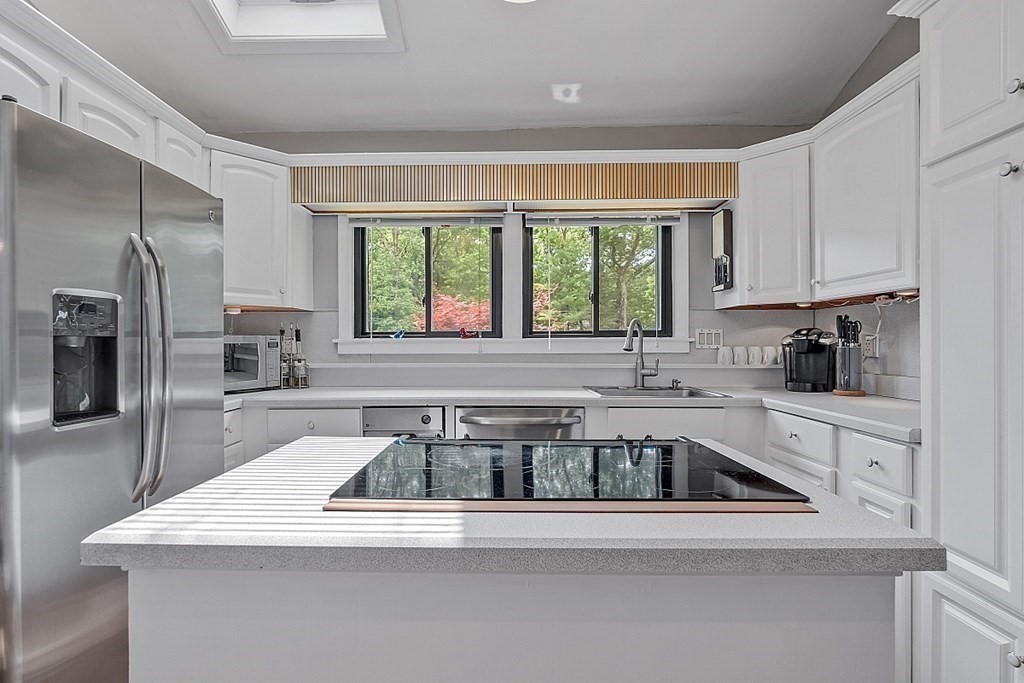 12 Sheridan Road Andover, MA 01810 - Photo 27 of 40 a view of a kitchen with a sink wooden cabinets and stainless steel appliances