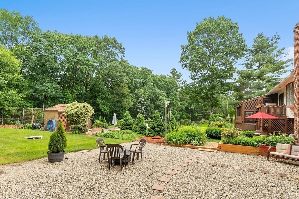 12 Sheridan Road Andover, MA 01810 - Photo 8 of 40 a view of a chair and table on the garden