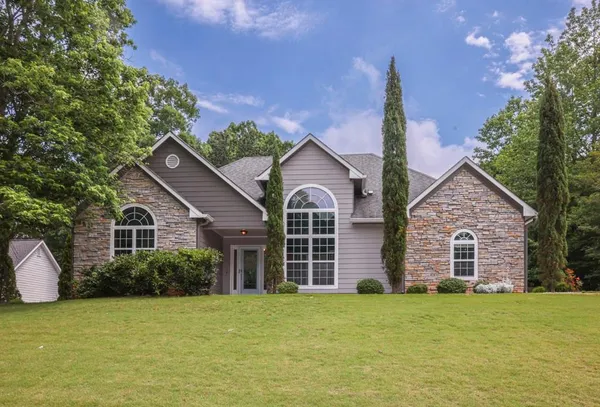 a view of a house with a garden and yard
