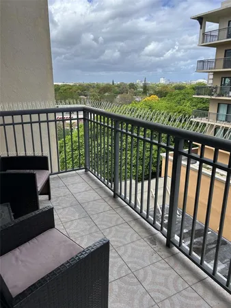 a view of a balcony with an outdoor seating