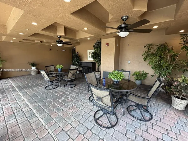 a view of a patio with table and chairs