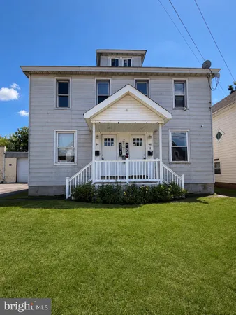 a view of a house with a yard and deck