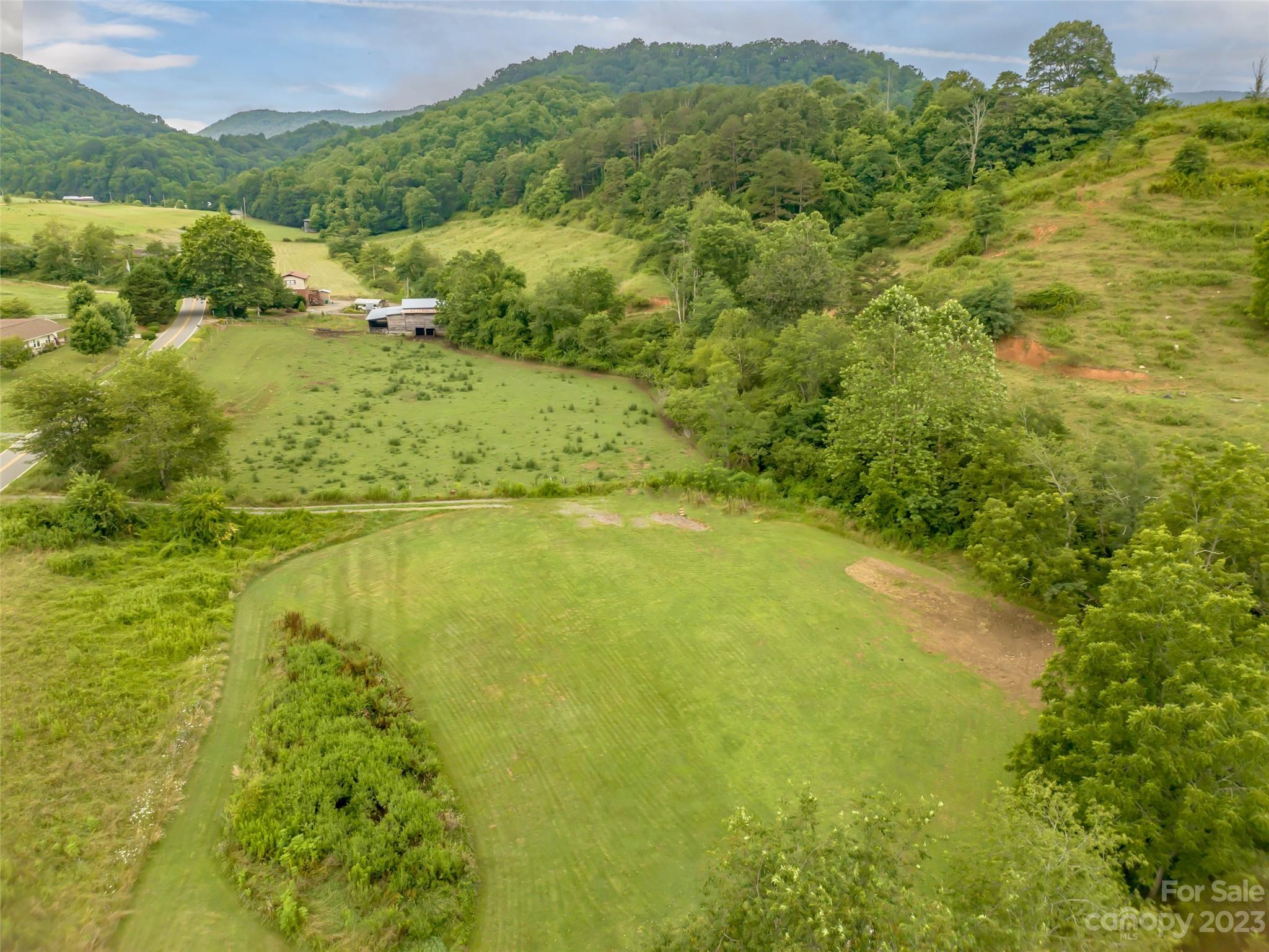 309 Sugar Creek Road Leicester, NC 28748 - Photo 21 of 23 a view of a lake with a mountain in the background