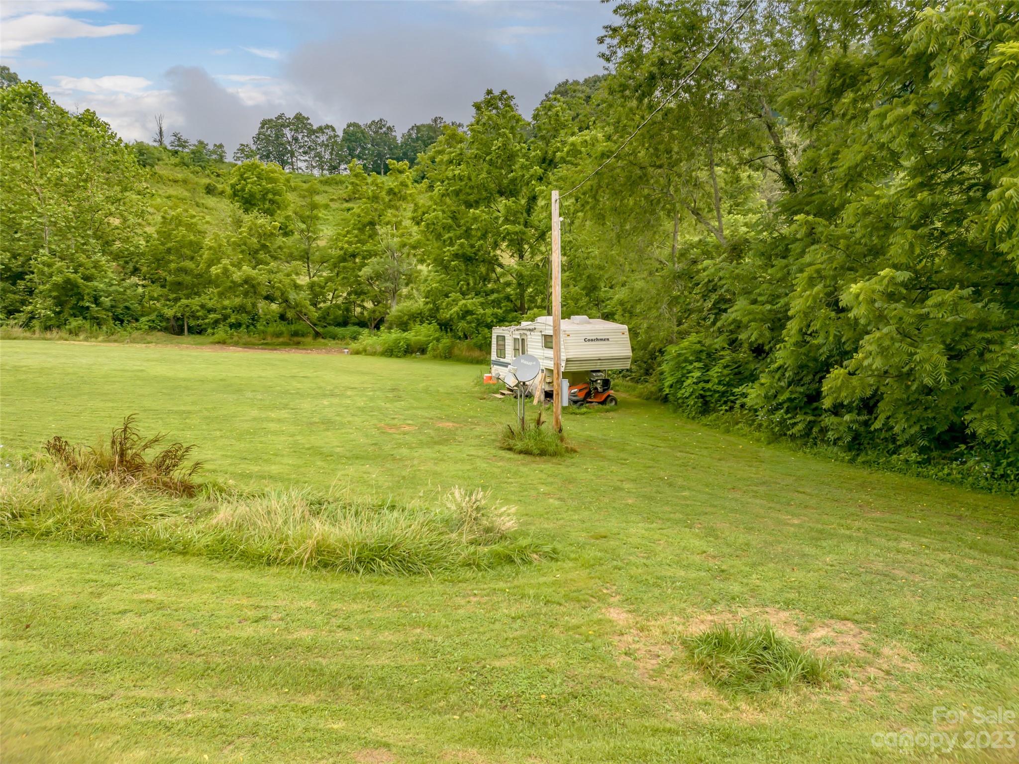 309 Sugar Creek Road Leicester, NC 28748 - Photo 10 of 23 a backyard of a house with lots of green space