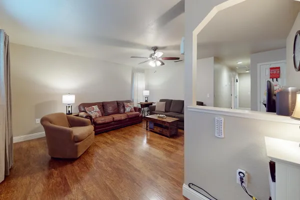 a living room with furniture and a wooden floor