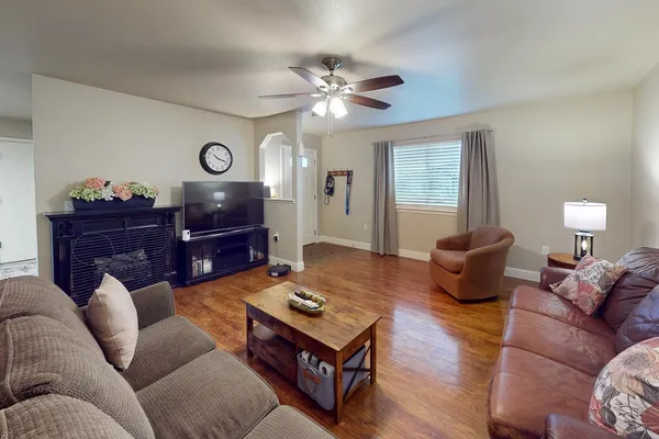 a living room with furniture a table and a chandelier