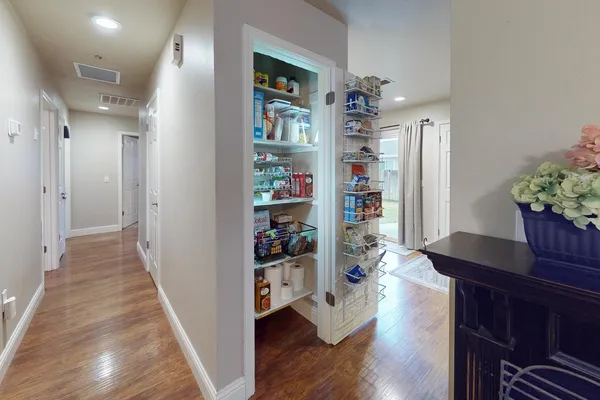 a room with wooden floor and potted plant