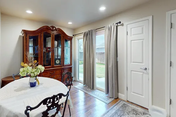 a view of a dining room with furniture and wooden floor