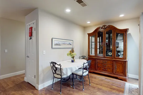 a view of a dining room with furniture and wooden floor