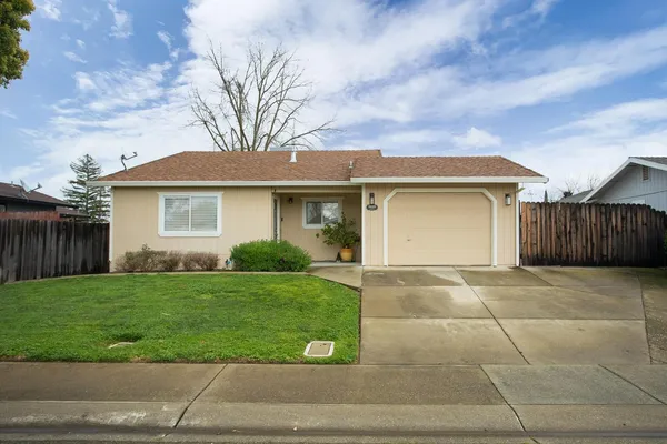 a view of a yard in front of a house with garage