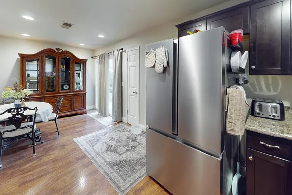 a kitchen with stainless steel appliances granite countertop a refrigerator and a stove top oven