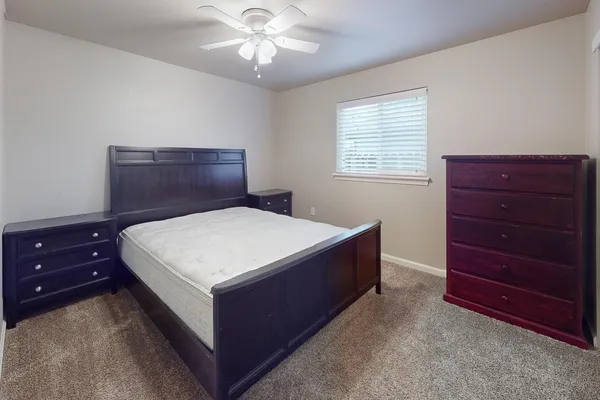 a bedroom with a bed and a dresser