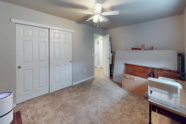 a spacious bedroom with a bed and a chandelier