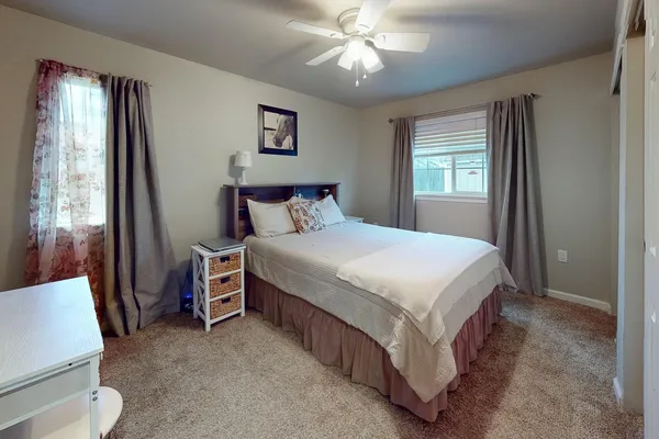 a bedroom with a bed and window