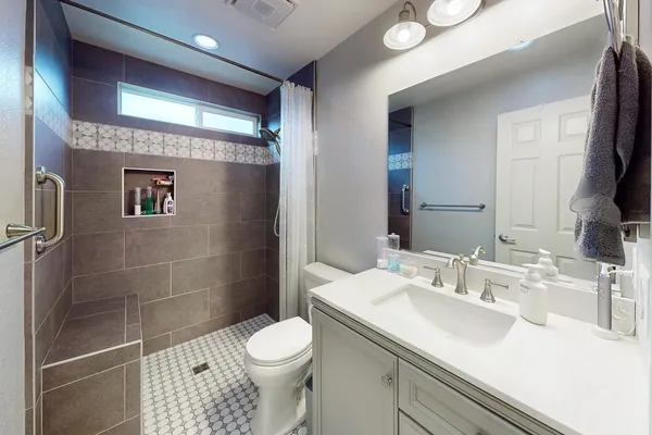 a bathroom with a sink toilet and shower
