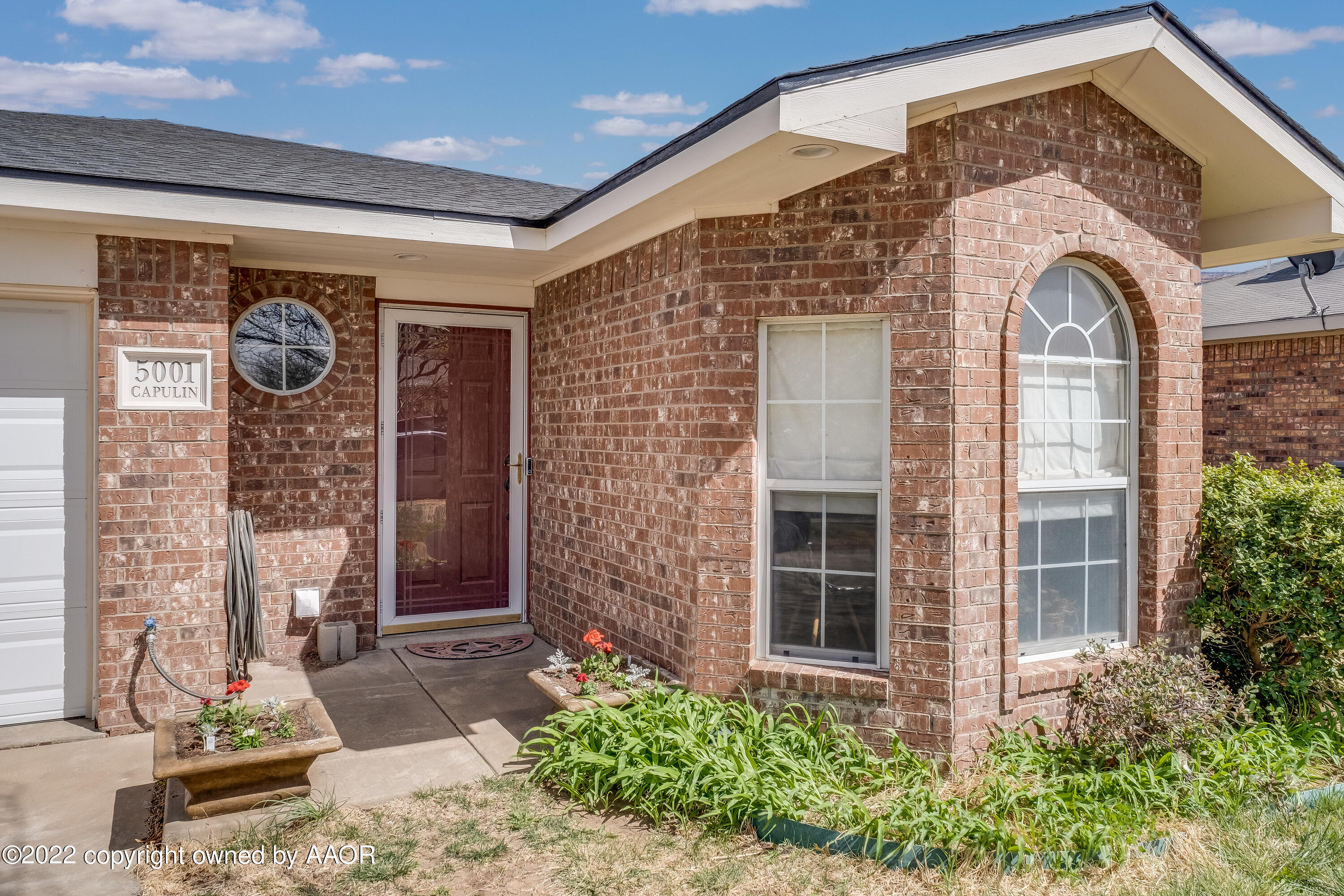 5001 Capulin Lane Amarillo, TX 79110 - Photo 1 of 22 a front view of a house with garden