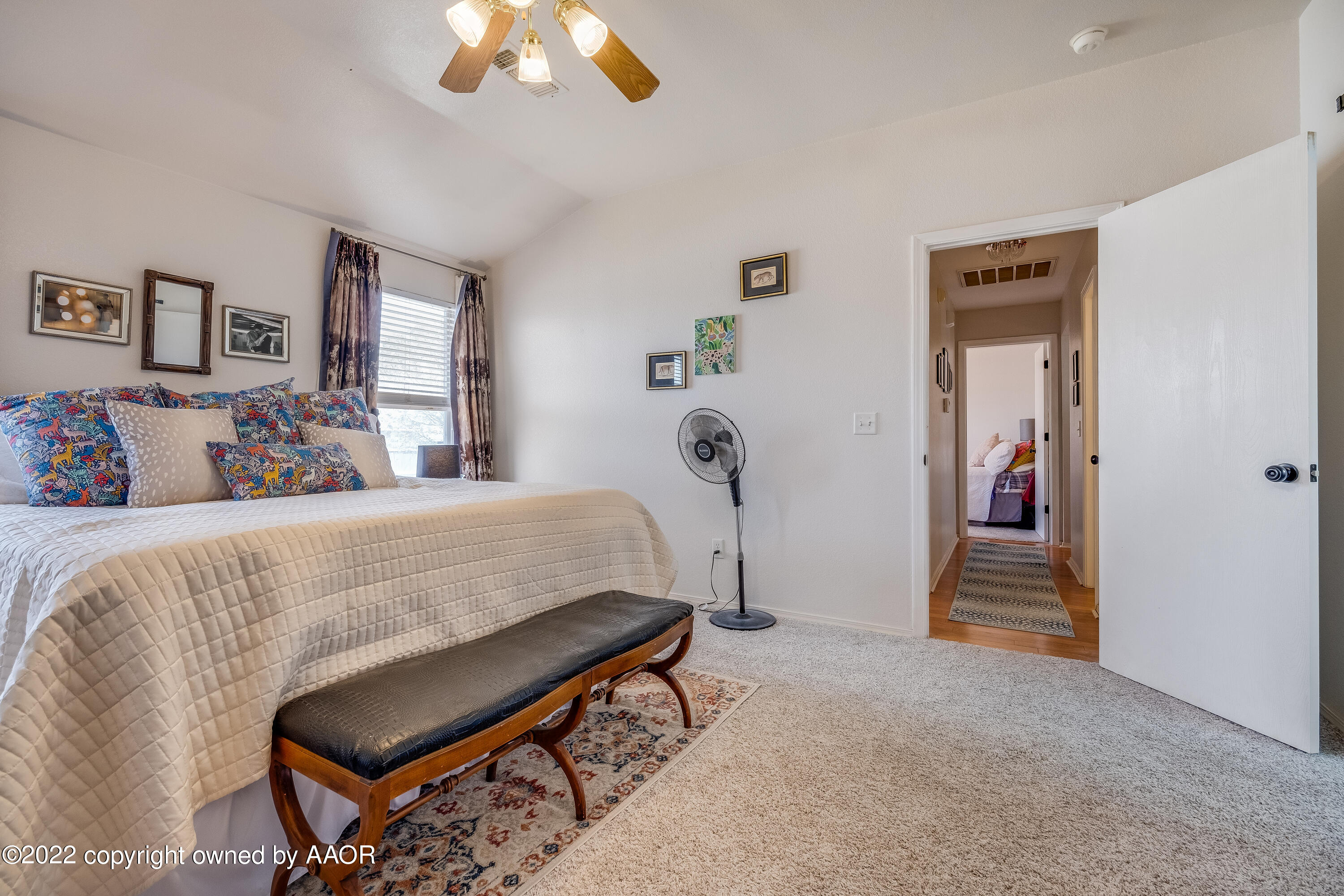 5001 Capulin Lane Amarillo, TX 79110 - Photo 13 of 22 a bedroom with furniture and a chandelier