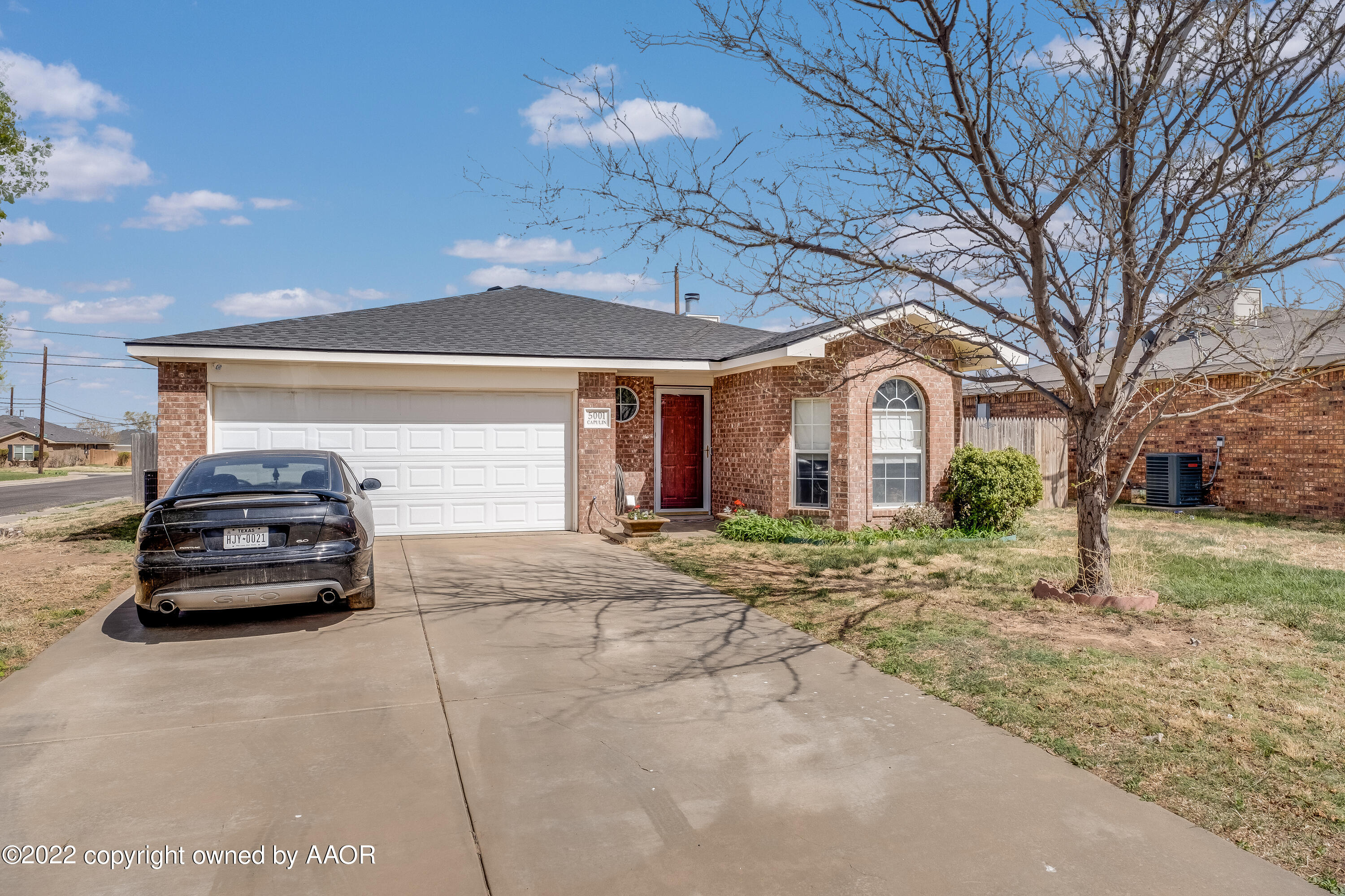 5001 Capulin Lane Amarillo, TX 79110 - Photo 2 of 22 a car parked in front of white house