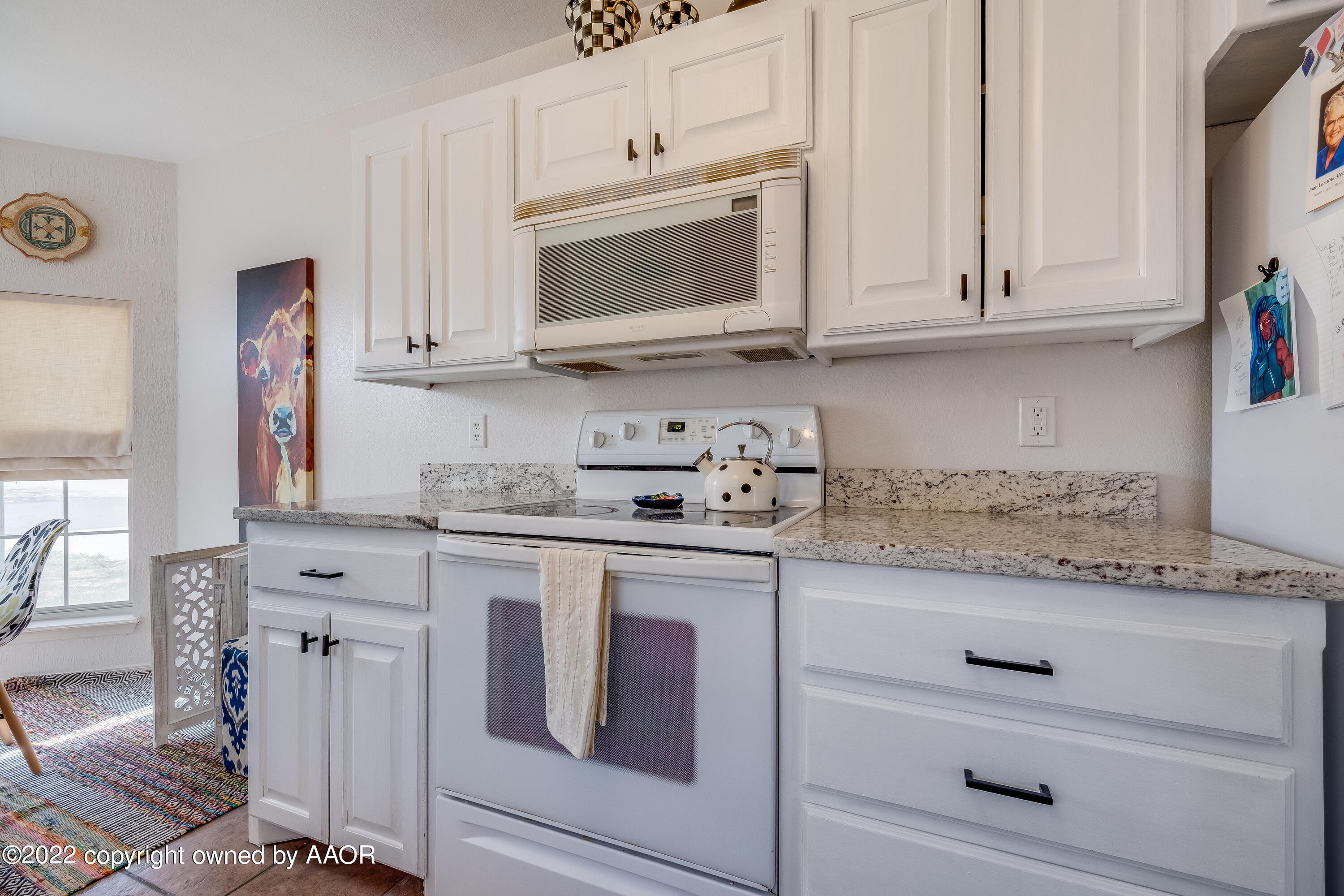 5001 Capulin Lane Amarillo, TX 79110 - Photo 4 of 22 a kitchen with granite countertop white cabinets and stainless steel appliances