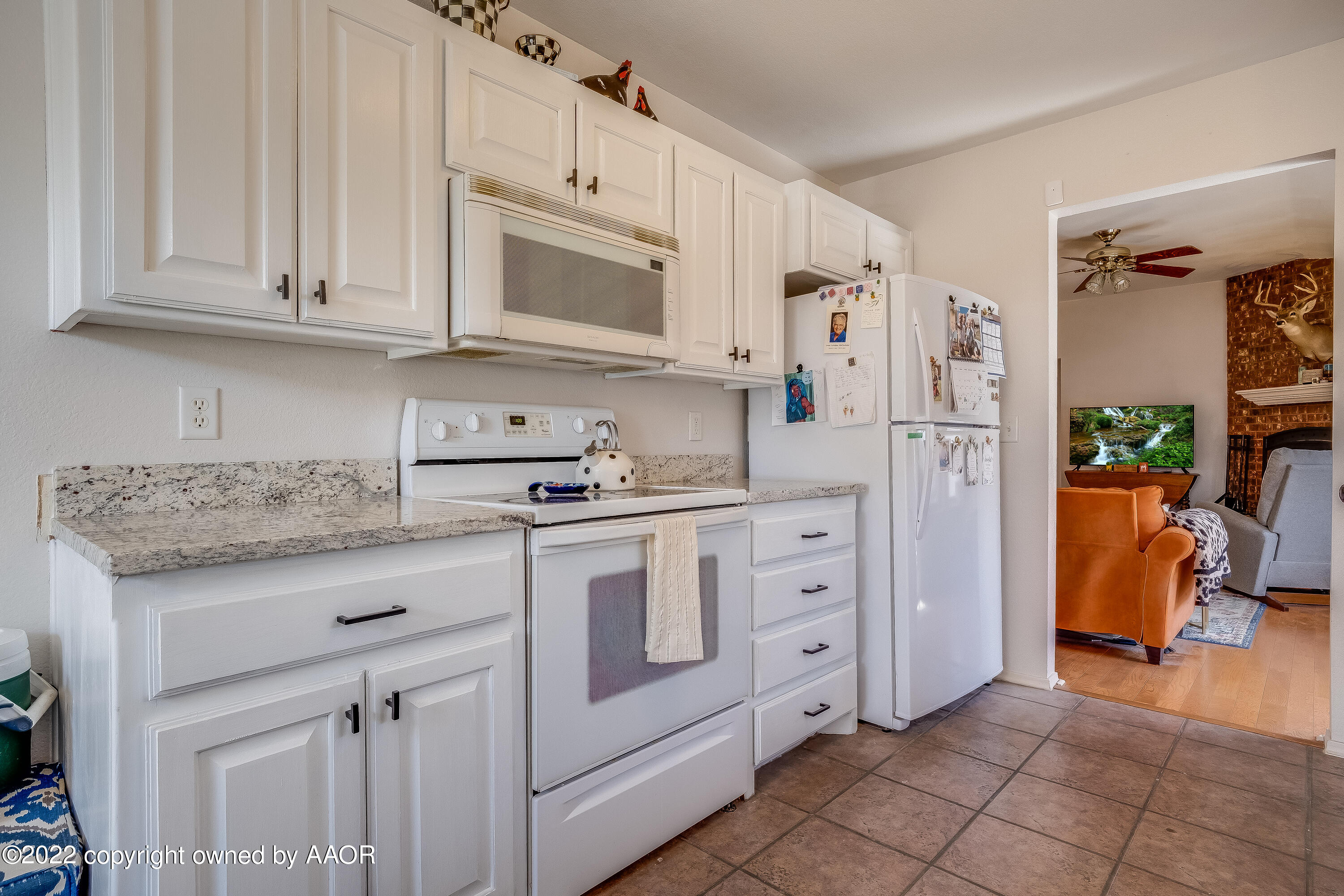 5001 Capulin Lane Amarillo, TX 79110 - Photo 6 of 22 a kitchen with white cabinets and white appliances