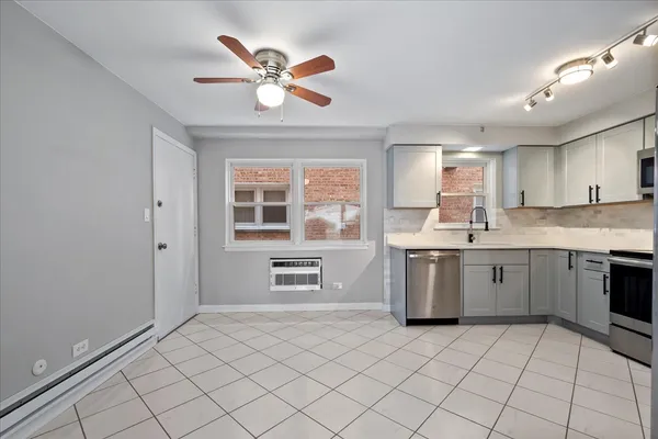 a kitchen with a stove sink and cabinets