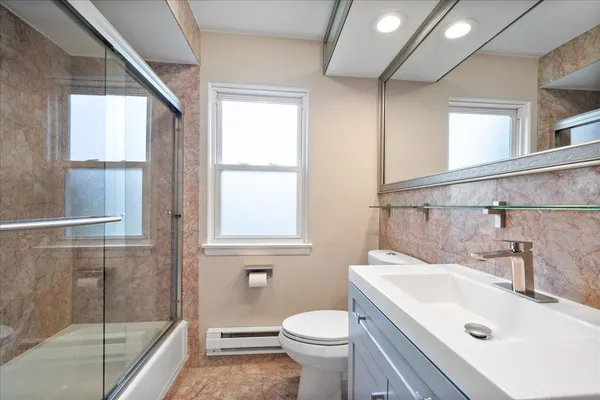 a bathroom with a sink toilet and shower