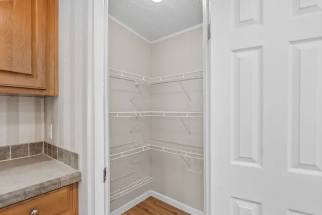 a bathroom with a granite countertop sink and white cabinets
