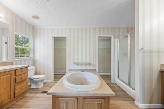 a bathroom with a sink a toilet and a mirror