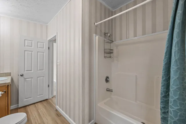 a bathroom with a bathtub and a shower