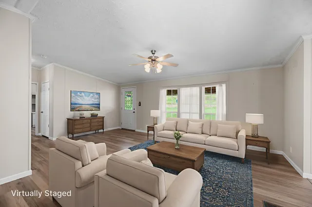 a living room with furniture and a ceiling fan