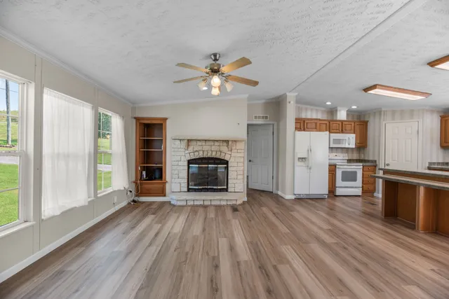 a view of a kitchen with a stove wooden cabinet and a refrigerator