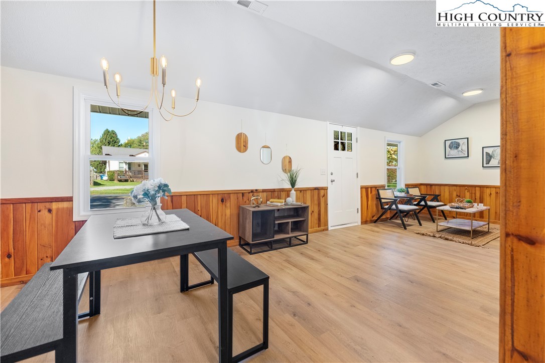 90 Camp Branch Road Waynesville, NC 28786 - Photo 11 of 34 a living room with furniture and a dining table with wooden floor
