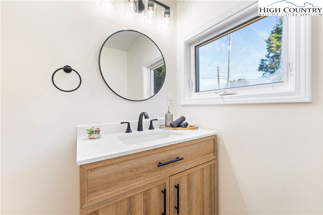 90 Camp Branch Road Waynesville, NC 28786 - Photo 14 of 34 a bathroom with a sink and a mirror