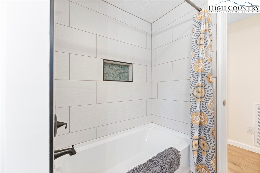 90 Camp Branch Road Waynesville, NC 28786 - Photo 16 of 34 a bathroom with a bathtub