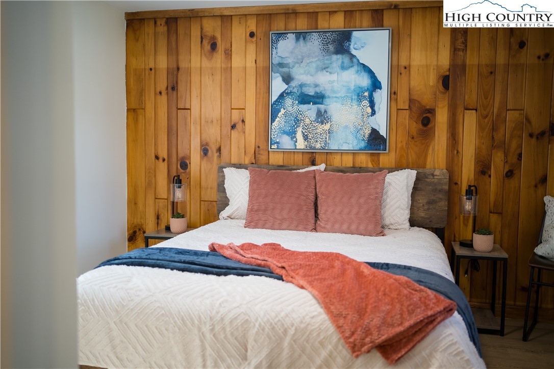 90 Camp Branch Road Waynesville, NC 28786 - Photo 19 of 34 a bedroom with a bed and a painting on the wall