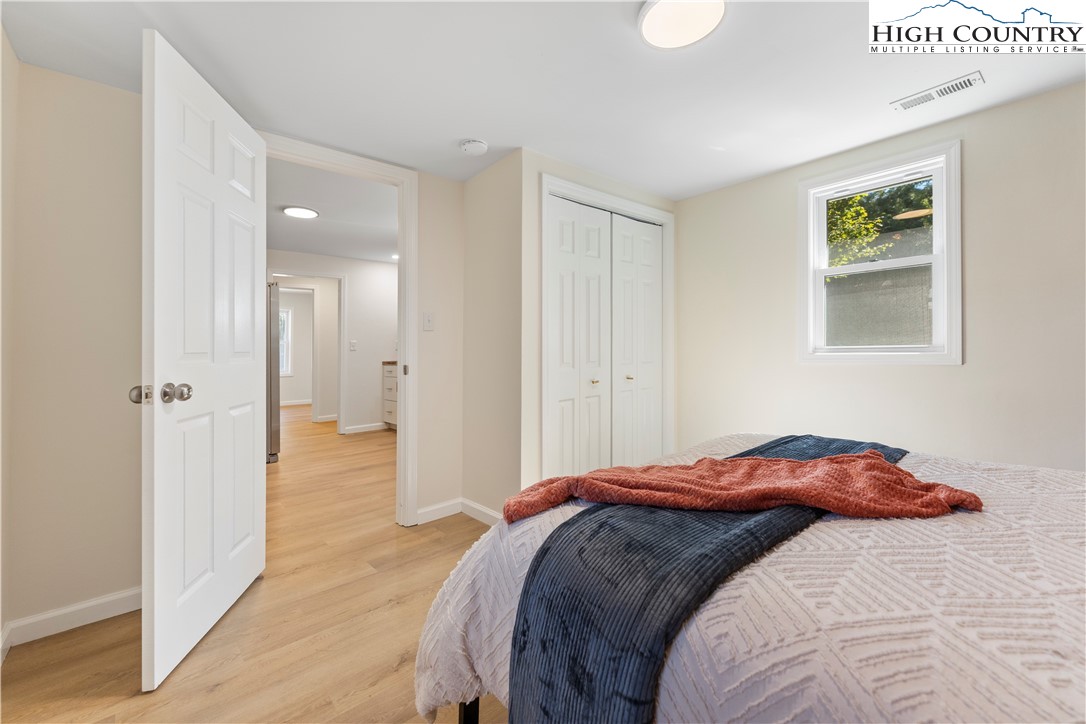 90 Camp Branch Road Waynesville, NC 28786 - Photo 20 of 34 a bedroom with a bed and a painting on the wall