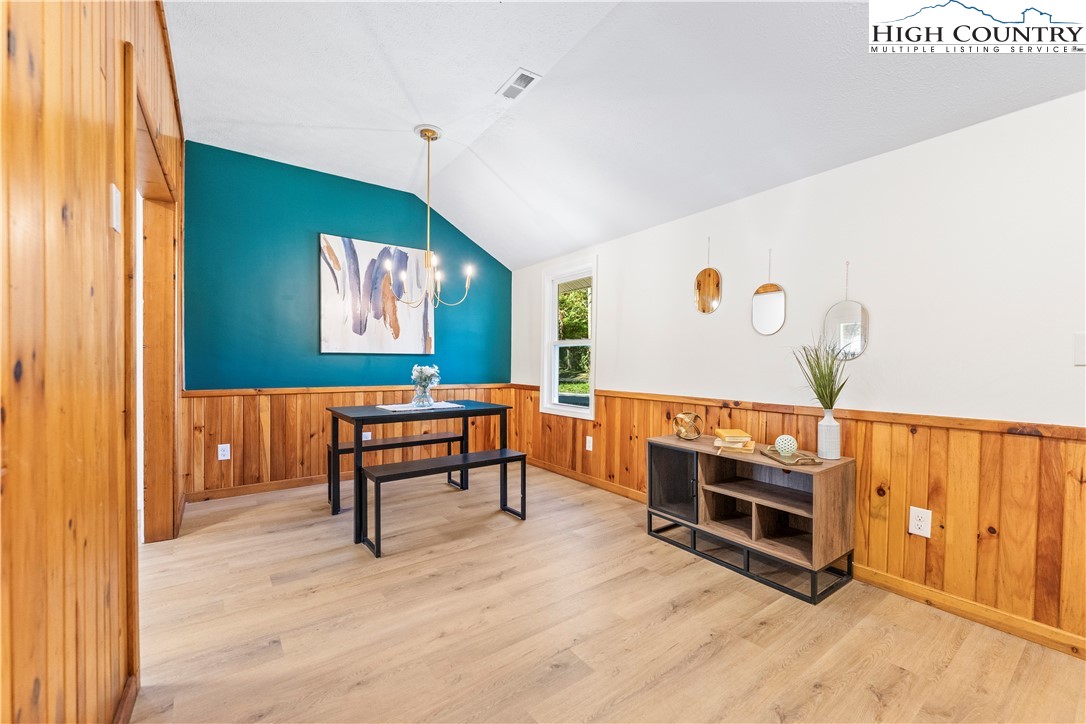 90 Camp Branch Road Waynesville, NC 28786 - Photo 2 of 34 a living room with furniture a fireplace and a flat screen tv