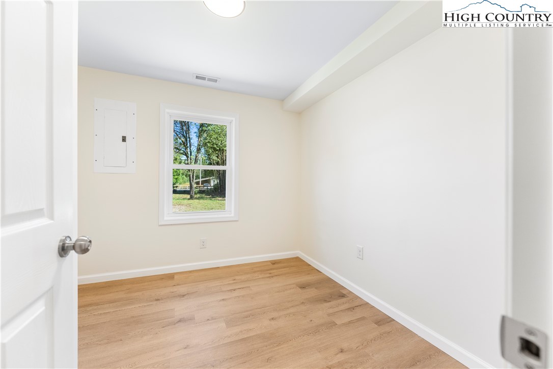 90 Camp Branch Road Waynesville, NC 28786 - Photo 21 of 34 a view of empty room with wooden floor