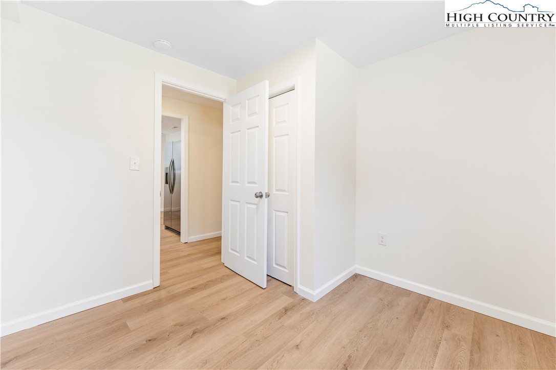 90 Camp Branch Road Waynesville, NC 28786 - Photo 22 of 34 a view of an empty room with wooden floor