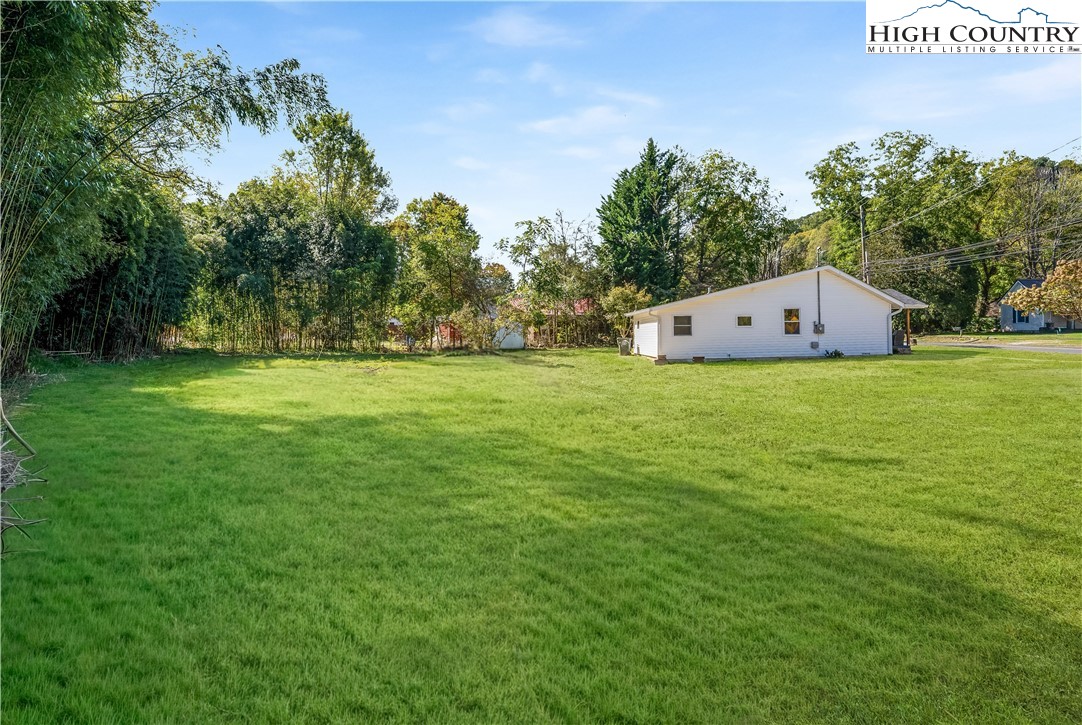 90 Camp Branch Road Waynesville, NC 28786 - Photo 31 of 34 a backyard of a house with lots of green space and plants