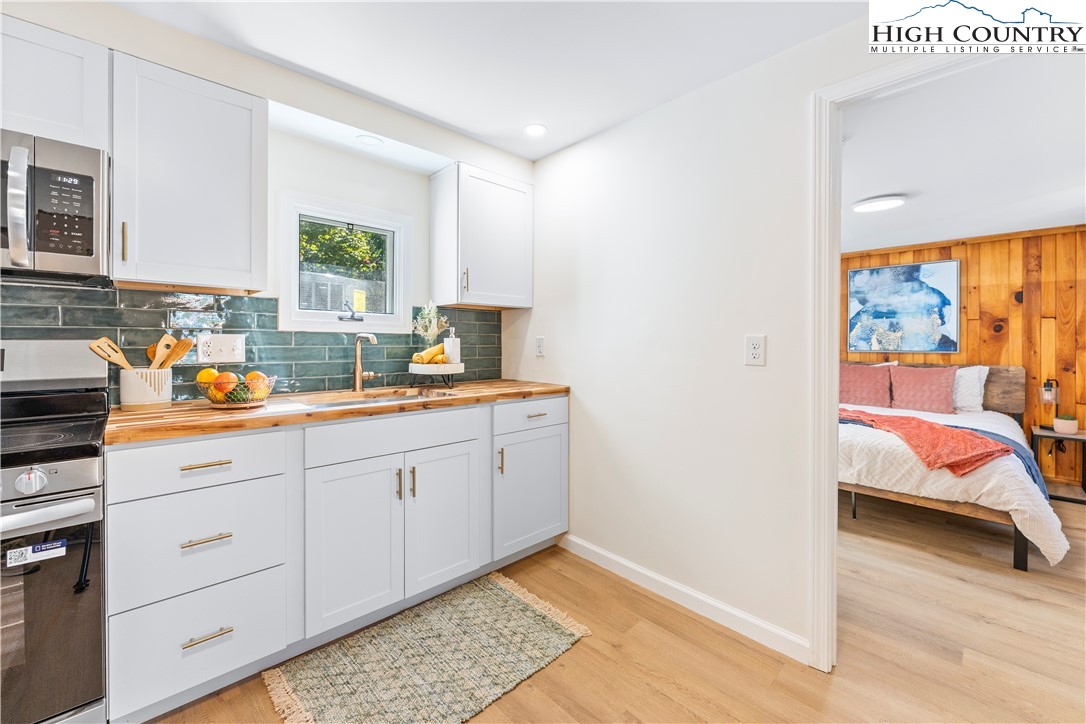 90 Camp Branch Road Waynesville, NC 28786 - Photo 7 of 34 a bedroom with a bed and a window