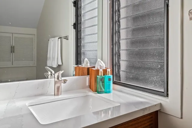 a view of a bath tub sitting in a bathroom next to a window