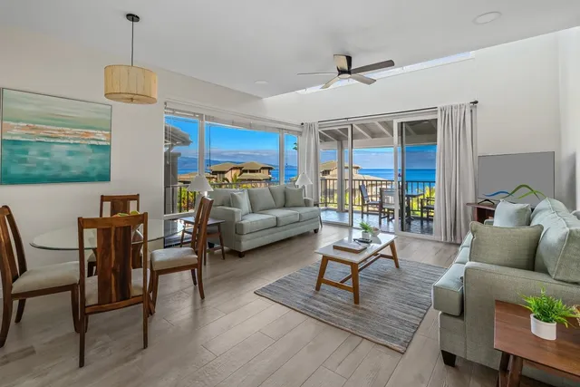 a living room with furniture a ceiling fan and a window