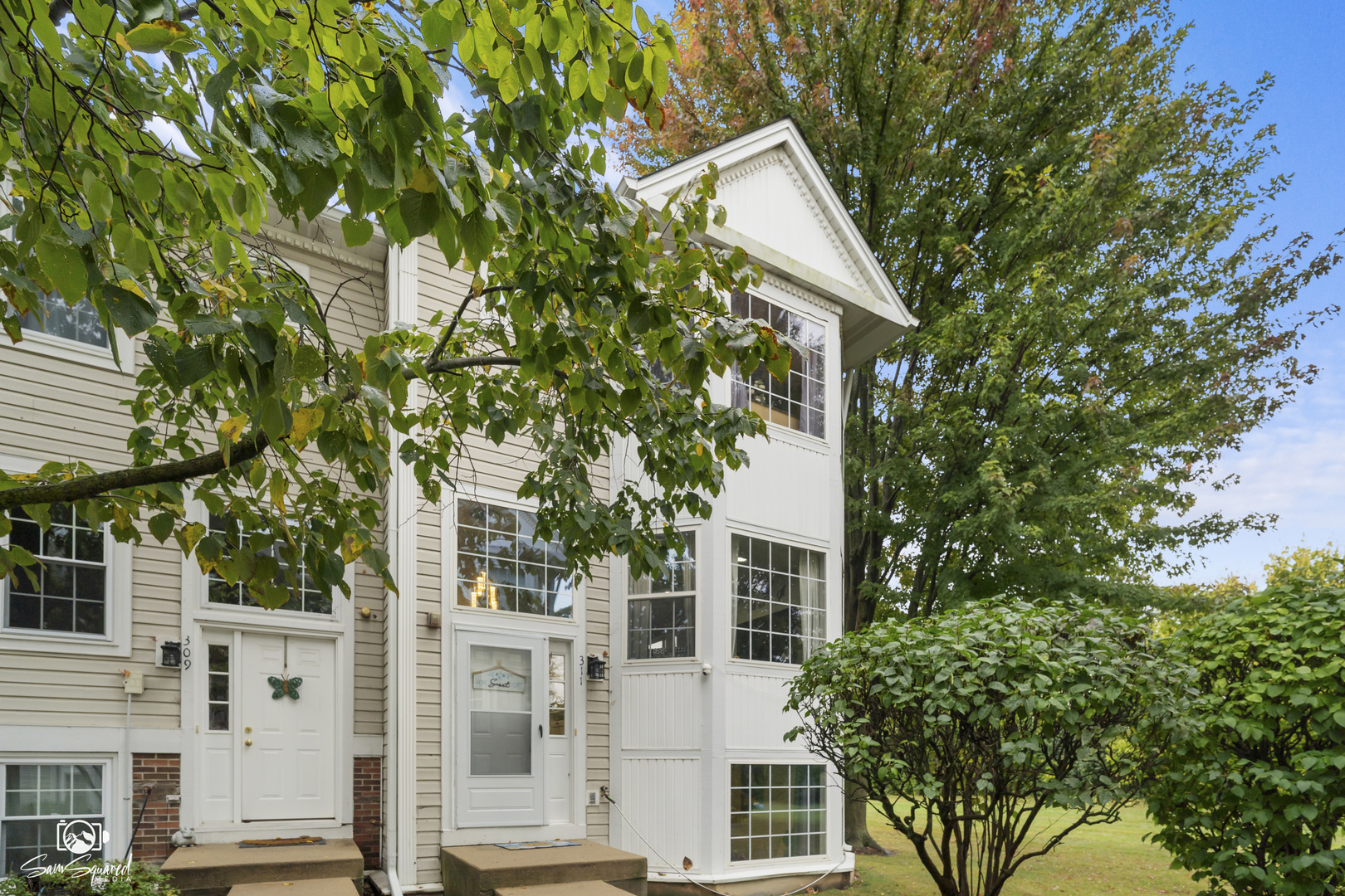 front view of a house with a tree